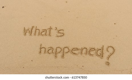 Handwriting words "What's happened?" on sand of beach