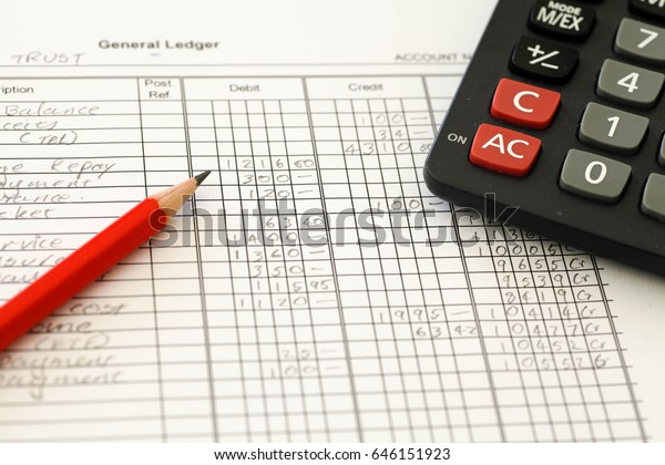 Handwritten Accounting ledger showing\
bookkeeping using pencil and\
calculator.