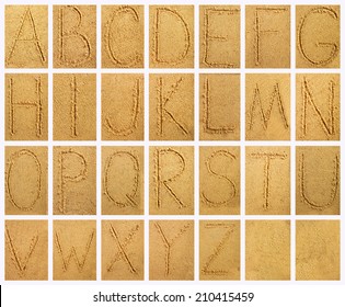 Handwritten alphabet letters on sand background