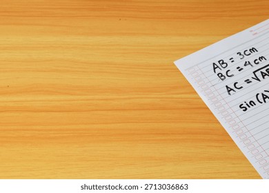 Handwritten geometry problem solving on lined paper. Calculation of the hypotenuse length (AC) using the Pythagorean theorem.