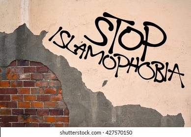 Handwritten graffiti Stop Islamophobia sprayed on wall, anarchist aesthetics. Appeal to stop hatred and prejudice against Muslims. Appeal to religious tolerance between religions 