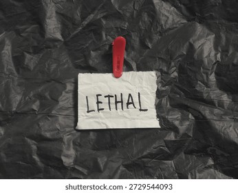 Handwritten lethal warning note, red clip on black plastic, dangerous chemical sign, toxic substance label, hazardous waste container, cautionary message, photo object, design material, graphic resource, raw picture, editable image, cut out, removable background 