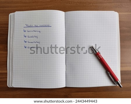 Handwritten list with four to do points on how to reach success in any field on a checkered notepad in cursive letters laying on a wooden table with a red pen. Copyspace on blank page.