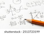 Handwritten mathematical equations, a sine wave graph, geometric shapes, and a right triangle diagram on white paper with a yellow pencil.