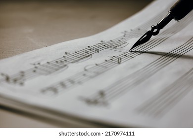 Handwritten music notes macro, music notes with ink pen in the background, selective focus - Shutterstock ID 2170974111