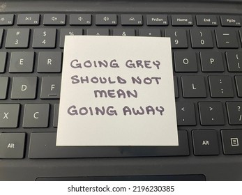 A Handwritten Note Stating Going Grey Should Not Mean Going Away. A Reference To Ageism And Age Discrimination In The Workplace