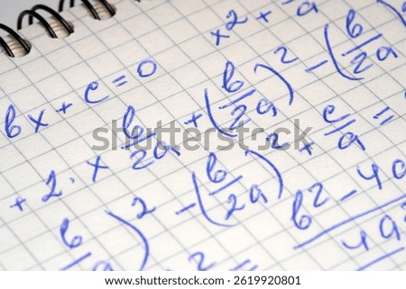 Handwritten notes showcase algebraic equations and calculations in a notebook.