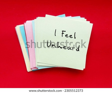 Handwritten text on paper note I FEEL UNHEARD, means to feel like nobody listens, feeling unheard by others around, your voice has not taken into account