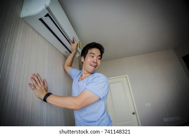 Handy Man Cleaning The Air Conditioner. Happy Family. Lovely Family. Asian Family. Family Man.