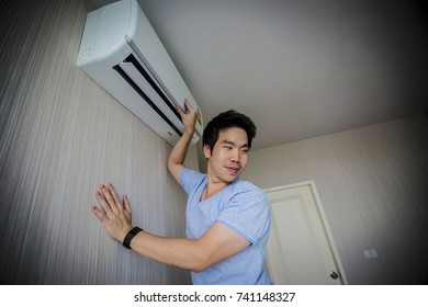 Handy Man Cleaning The Air Conditioner. Aa