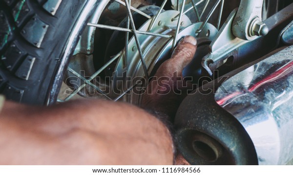 handy man fix motorcycle
wheel