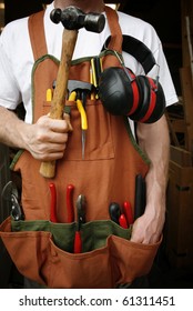 Handy Man In Front Of Work Shop Holding Hammer