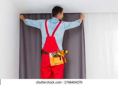 Handy Man Home Installation And Repair Service Technician Or Home Owner Hanging Curtains For The Window Treatment In A New House.