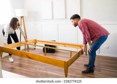 Handy Young Woman And Man Assembling A Bed Frame And Furniture Together In The Bedroom 