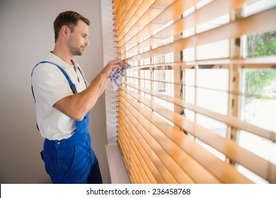 Handyman Cleaning Blinds With A Towel In A New House