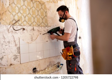 Handyman Drilling A Wall Wearing Protective Gear And Breathing Respiration Mask