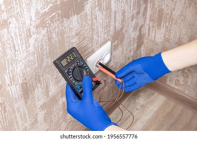 Handyman Electrician Measuring Wall Outlet Voltage At Living Room. Outlet Repair Concept. Test House Wiring Conceptual.