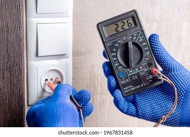 Handyman Electrician Measuring Wall Outlet Voltage At Living Room. Outlet Repair Concept. Test House Wiring Conceptual.