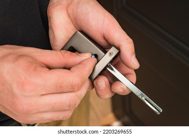 Handyman holding a doorknob and hex key, doorknob installation, metal doorknob.