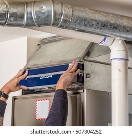 Handyman Inserts A Furnace Filter