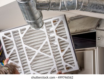 Handyman Inspects A Filter From A Home Furnace