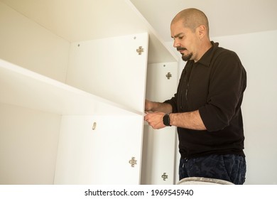 Handyman Man Assembling A Closet In A Moving House