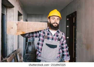A handyman relocating wooden beam in a building in construction process.