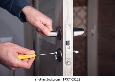 handyman repair the door lock in the room