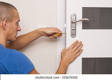 Handyman Repair The Door Lock In The Room