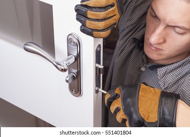 Handyman Repair The Door Lock In The Room