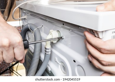 Handyman Repair Washer At Back Side. Washing Machine Repair Service Concept. Connecting Water Supply To Appliance.