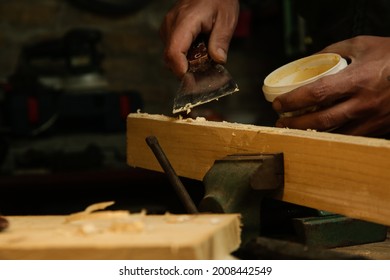 Handyman Is Smoothing Wooden Plank With Skim Coat. Applaying Putty On A Piece Of Wood.	
