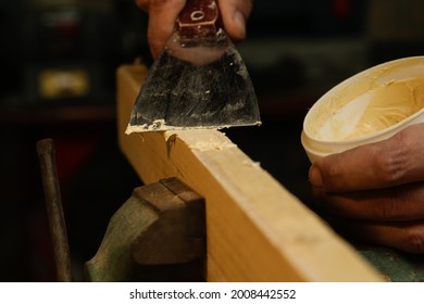 Handyman Is Smoothing Wooden Plank With Skim Coat. Applaying Putty On A Piece Of Wood.	
