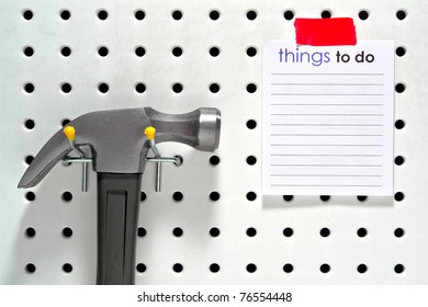 Handyman Things To Do Project List On A Blank Notepad Leaflet With Flat Copy Space For Text Insert On A Home Workshop Tool Pegboard With Hanging Construction Hammer