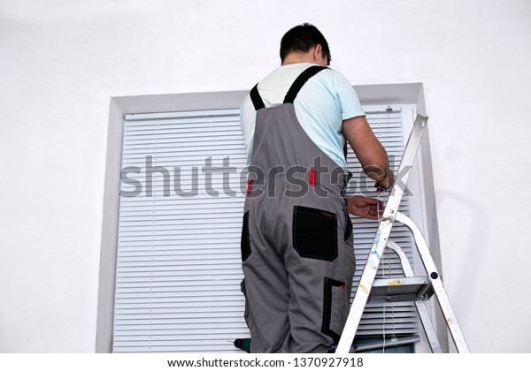 Handyman Uniform Installing New Window Blinds Stock Photo Edit Now 1370927918