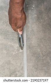 A Handyman Uses A Diamond Spline Roller To Press A Screen Mesh Into The Frame Edges. Window Screen Installation.