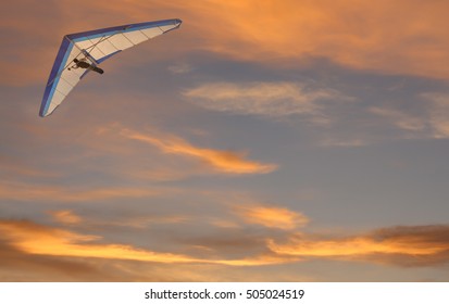 Hang Glider Fling Over The Ocean At Sunset