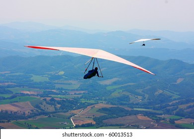 Hang Glider Flying In The Italian Mountains