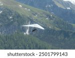 Hang gliding above mountain valley near Jenner mount and Konigssee lake in Berchtesgaden National Park, Germany, Europe. Beauty of nature concept background.