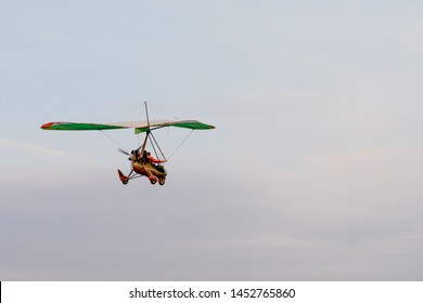 Hang Gliding High Up In The Air Amongst The Clouds, Extreme Sports And Recreation Background With Copy Space. Two People Fly Togetherness Recreational Activity Hang Glide Outdoors Adventure Concept.