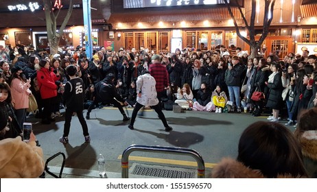 Hangdae, Seoul/Korea - December 20 2018: Huge Crowd Watching Korean Cover Dancers Performing On The Street At Night. Kpop Cover Dancing.