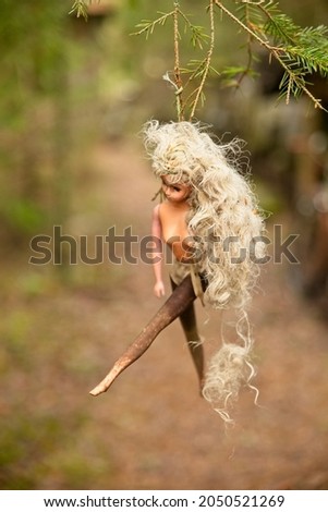 A hanged blond barby doll
