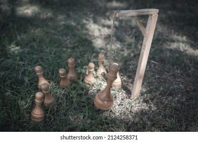 Hanged chess king, pawns stand nearby.The concept of revolution, the fall of the dictatorial regime as a result of a coup, uprising, rebellion, rebellion, coup d'etat