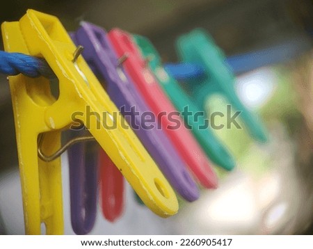 hanger, colorful, plastic material. deep focus, to glue the washed clothes together so they don't fly away in the wind.