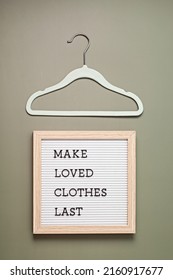 Hanger with letter board and text made loves clothes last. Slow fashion, circular economy, eco friendly sustainable shopping, thrift second hand shop concept.