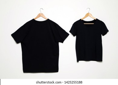 Hangers with blank t-shirts on white background. Mock up for design - Shutterstock ID 1425255188