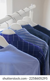 hangers with clothes, wardrobe shirt jacket blue. storing clothes or shopping. stylist selection of look for work and walking. fashion and casual wear - Shutterstock ID 2258605295