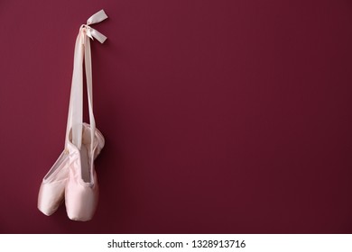 Hanging Ballet Shoes On Color Wall