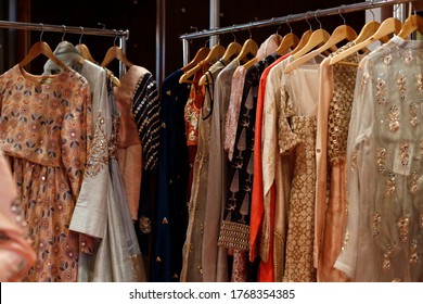 Hanging beautiful indian dresses different colors and decoration at market, shop, boutique, bazaar, fashion clothes designer collection