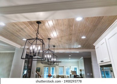 Hanging black metal iron lighting fixtures in a newly renovated kitchen - Powered by Shutterstock